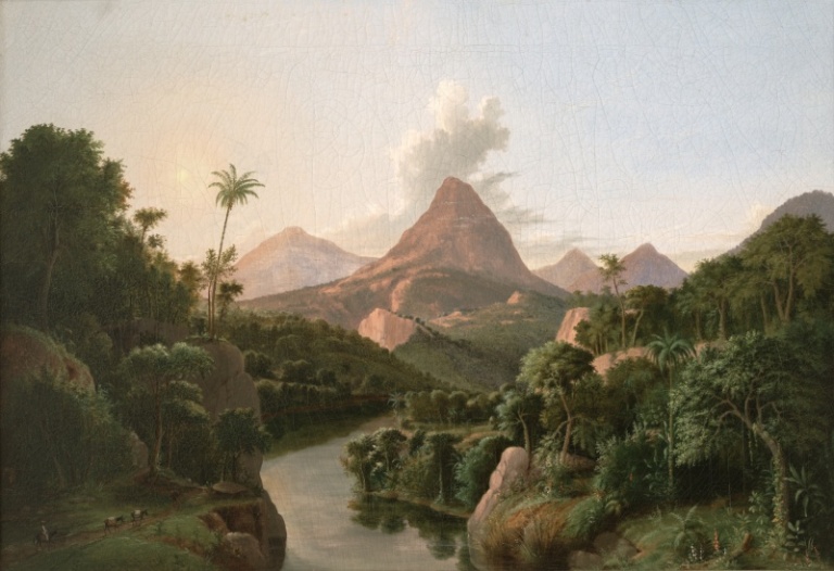 A tropical landscape with a river in the foreground and several mountains in the background